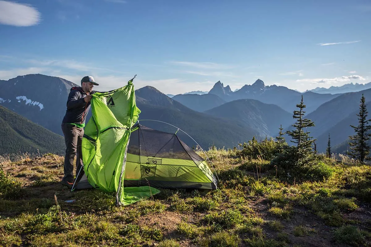 Lightweight backpacking tent setup in mountain terrain